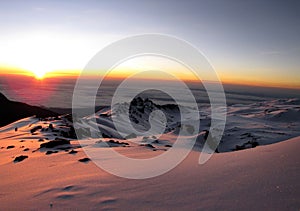 Beautiful landscape of Mount Kilimanjaro covered in snow at a mesmerizing sunset