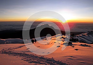 Beautiful landscape of Mount Kilimanjaro covered in snow at a mesmerizing sunset