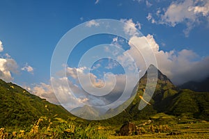 Beautiful landscape mountain green field grass meadow white cloud blue sky on sunny day. Majestic green scenery big mountain hill