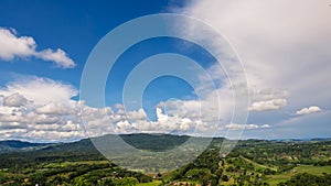 Beautiful landscape mountain green field grass meadow white cloud blue sky on sunny day. Majestic green scenery big mountain hill