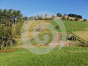 Beautiful landscape of mountain Kopaonik in Serbia, small house on green field, rural scene, majestic pitoresque view.