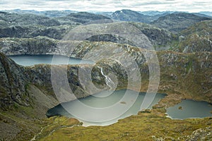 A beautiful landscape of a mountain lake in Folgefonna National Park in Norway. Overcast autumn day in mountains.