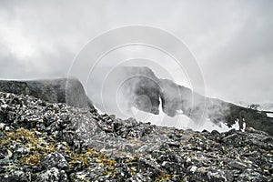 Beautiful landscape with mountain lake in front of mountain range during cloudy day