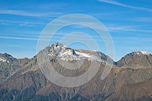 Beautiful landscape in the mountains with peaks against the blue sky and valleys covered