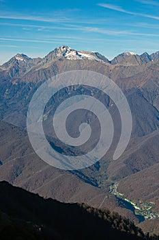 Beautiful landscape in the mountains with peaks against the blue sky and valleys covered