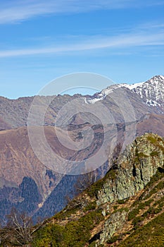 Beautiful landscape in the mountains with peaks against the blue sky and valleys covered
