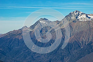 Beautiful landscape in the mountains with peaks against the blue sky and valleys covered