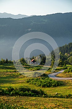 Beautiful landscape with mountains and a valley with house and road at sunset with blue sky. View of the valley in Georgia