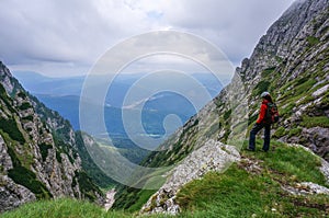 Beautiful landscape in the mountains and woman climber admiring the view