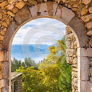 Beautiful landscape at Nafplio in Greece through the old arched stoney doorway of Palamidi castle.