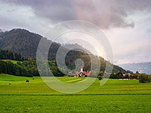 Beautiful landscape of North Italy with green field and mountains.