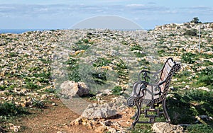 Beautiful Landscape with a old, lonely bank on Dingli Cliffs in a field of stones.