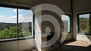 Beautiful landscape out of wide window of an abandoned hotel