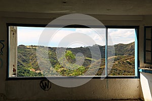 Beautiful landscape out of wide window of an abandoned hotel