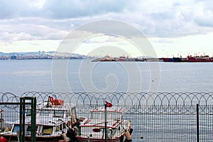 Beautiful landscape photo of harbor with moored fishing boats and ships in Istanbul. Cityscape in the background