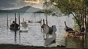 Beautiful landscape in Phuket with fishing boats at sunset