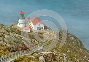 Beautiful landscape, Point Reyes lighthouse on the rocky coast of the Pacific Ocean, a long staircase leads to it