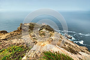 Beautiful landscape, Point Reyes lighthouse on the rocky coast of the Pacific Ocean, a long staircase leads to it