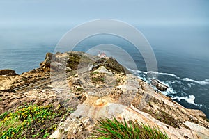 Beautiful landscape, Point Reyes lighthouse on the rocky coast of the Pacific Ocean, a long staircase leads to it
