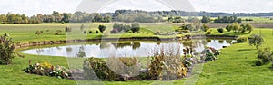 Beautiful landscape with pond, meadow and trees