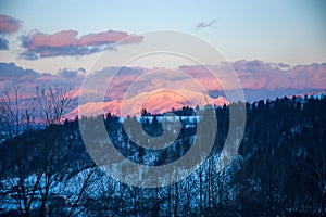 Beautiful landscape of Postavaru Mountains at sunset in a cold and sunny day during winter season