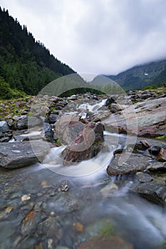 Beautiful landscape of rapids on a mountain river. Long exposure image. Fagaras Mountains.Transylvania. Romania.