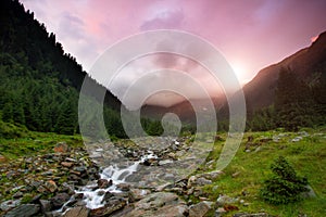 Beautiful landscape of rapids on a mountain river at sunrise. Long exposure image. Fagaras Mountains.Transylvania. Romania.