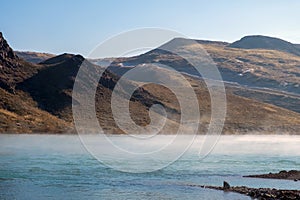 Beautiful landscape with river and evaporations above river in autumn.