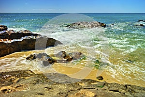 Beautiful landscape with rocks and sea waves on a beach