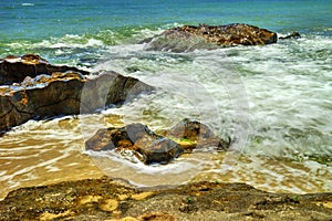 Beautiful landscape with rocks and sea waves on a beach