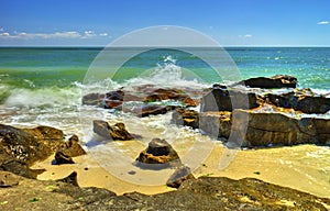 Beautiful landscape with rocks and sea waves on a beach
