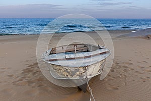 Beautiful landscape of rusty boat on the beach in sunrise. Vintage Boat in the seashore. Kazakstan, Caspian Sea