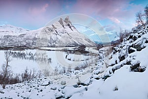 Beautiful landscape scene with Signaldalelva river and Otertinden mountain in background in Northern Norway . Sunset