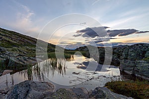 Beautiful landscape scenery with lake, and dramatic skies in the background. photo