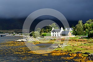 Beautiful landscape in Scotland with a house right on the water