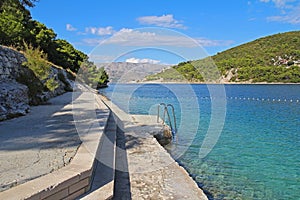 Beautiful landscape of sea Coast of Adriatic sea with a promenade and transparent blue water in Pucisca, Croatia. Island of Brac photo