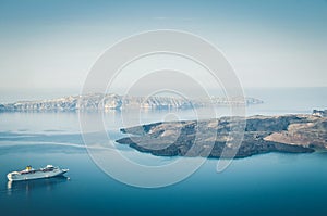 Beautiful landscape with sea view. Cruise liner at the sea near the Nea Kameni, a small Greek island in the Aegean Sea near Santor