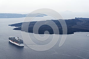 Beautiful landscape with sea views. Cruise ship in sea near NEA Kameni, a small Greek island in the Aegean sea near Santorini.