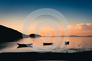 Beautiful landscape with silhouette of boats during sunset in Lake Titicaca, Isla del Sol, Bolivia