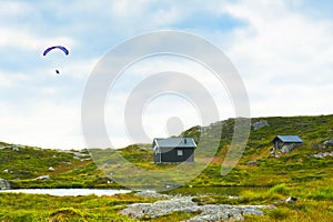 Beautiful landscape with small houses and paraglider seen from way to the Mount Ulriken peak in Bergen, Norway