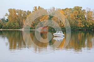 Beautiful landscape of speed boat and island on the calm water of Dnipro River. Ukraine, Kiev, Obolon.