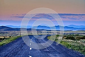 Beautiful landscape of steppe and stone mountains along the road from the city of Ust-Kamenogorsk to the Sibiny lakes RU: