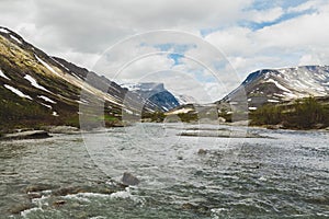 Beautiful landscape. A stormy river against the backdrop of the mountains.