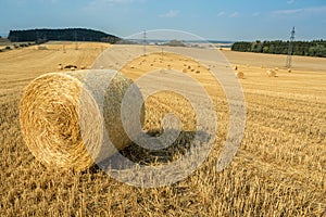 Beautiful landscape with straw bales in harvested fields