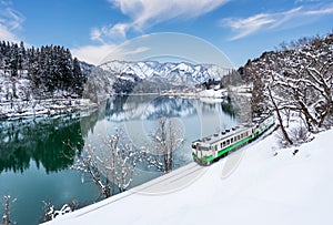 Beautiful landscape of Tadami line train across Tadami river in winter at Fukushima, Japan