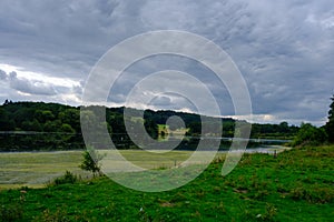 Beautiful landscape of trees foliage birds and the Fish Pond  in the area of the Harewood House Trust in West Yorkshire in the