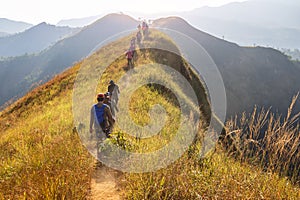 Beautiful landscape with trekkers walking on mountain ridge in sunset at Khao Chang Phuak, Thong Pha Phum National Park,