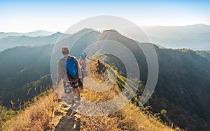 Beautiful landscape with trekkers walking on mountain ridge in sunset at Thong Pha Phum National Park Kanchanaburi of Thailand