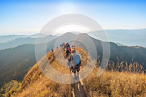 Beautiful landscape with trekkers walking on mountain ridge in sunset at Thong Pha Phum National Park Kanchanaburi of Thailand