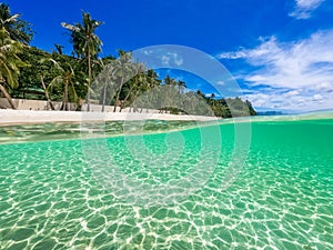 Beautiful landscape on the tropical beach of Boracay island, Philippines. Coconut trees, sea, sailboat and white sand. View of nat